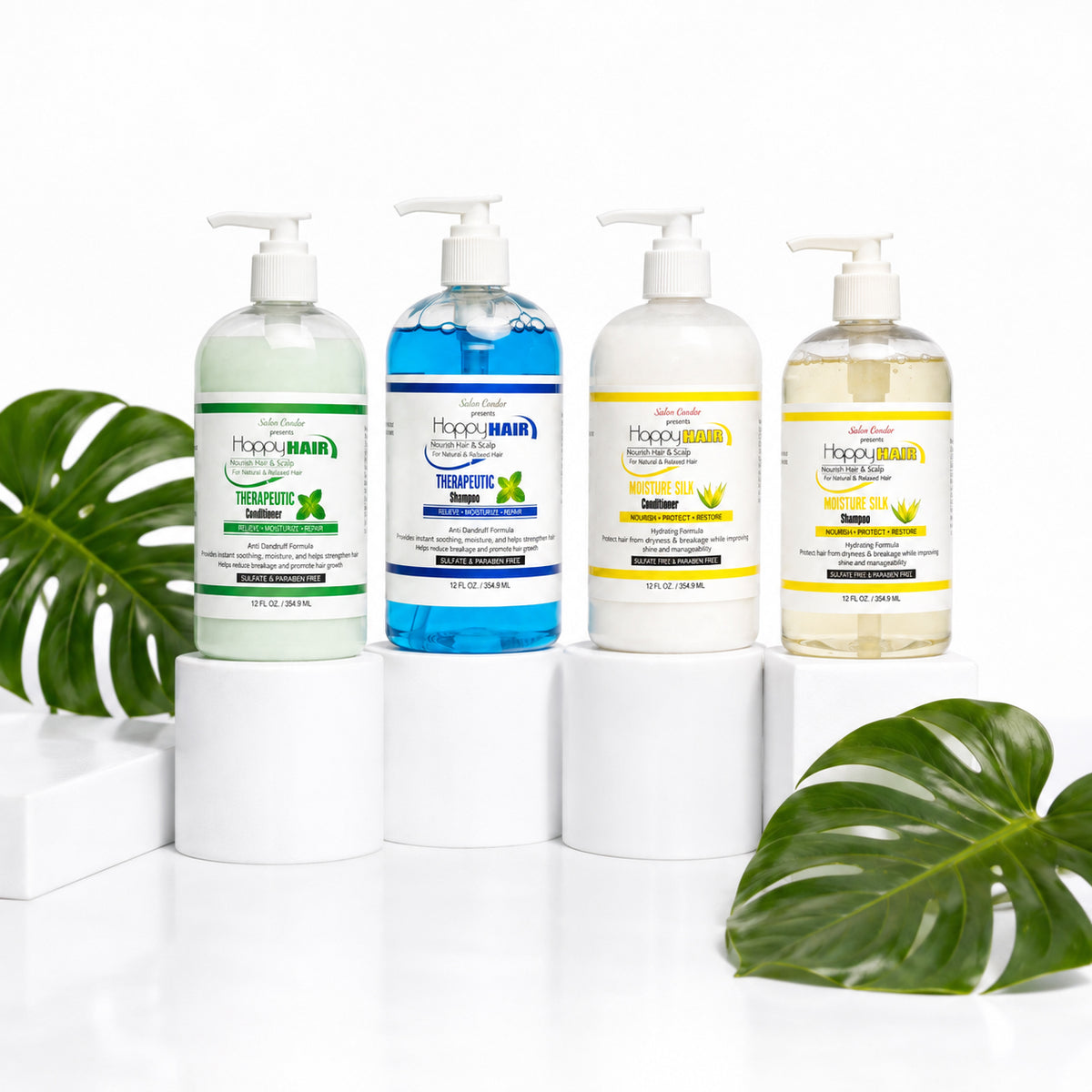 Four pump bottles of  Salon Candies products arranged on white pedestals, with green monstera leaves at the sides on a white background.