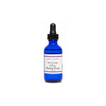 A cobalt blue glass dropper bottle of Salon Candies Hair & Scalp Therapy Healing Drops on a plain white background.