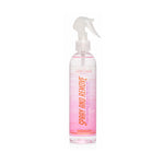 A clear plastic spray bottle with a white trigger sprayer, containing a pink liquid. The label features vertical text reading 'SPRAY AND REMOVE' in orange, with 'Shag Color' written at the top, set against a plain white background.